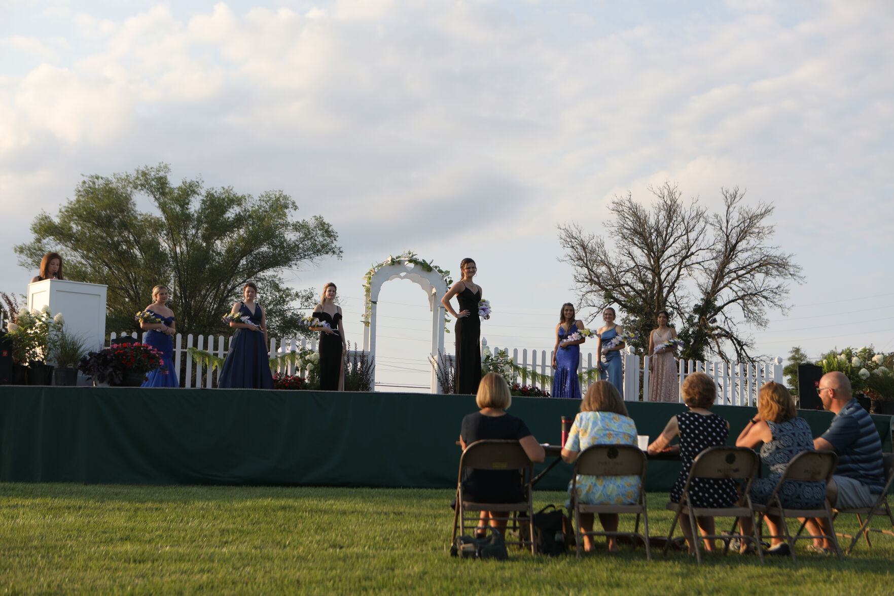 Queen contestants stand on stage